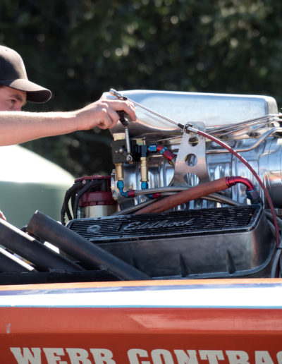 Man starting hydroplane boat engine