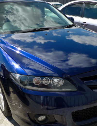 Right headlight on blue car after repair