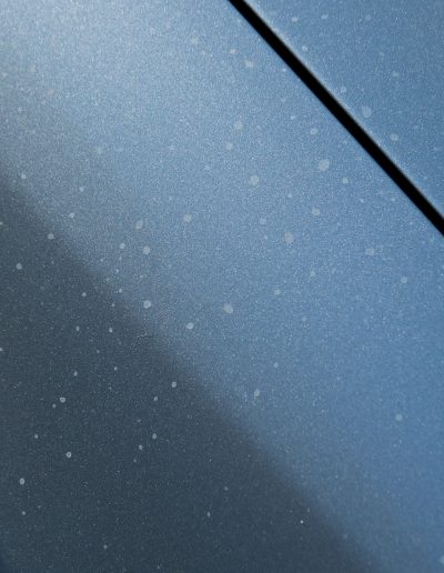 Hard mineral water spots on car paint fender