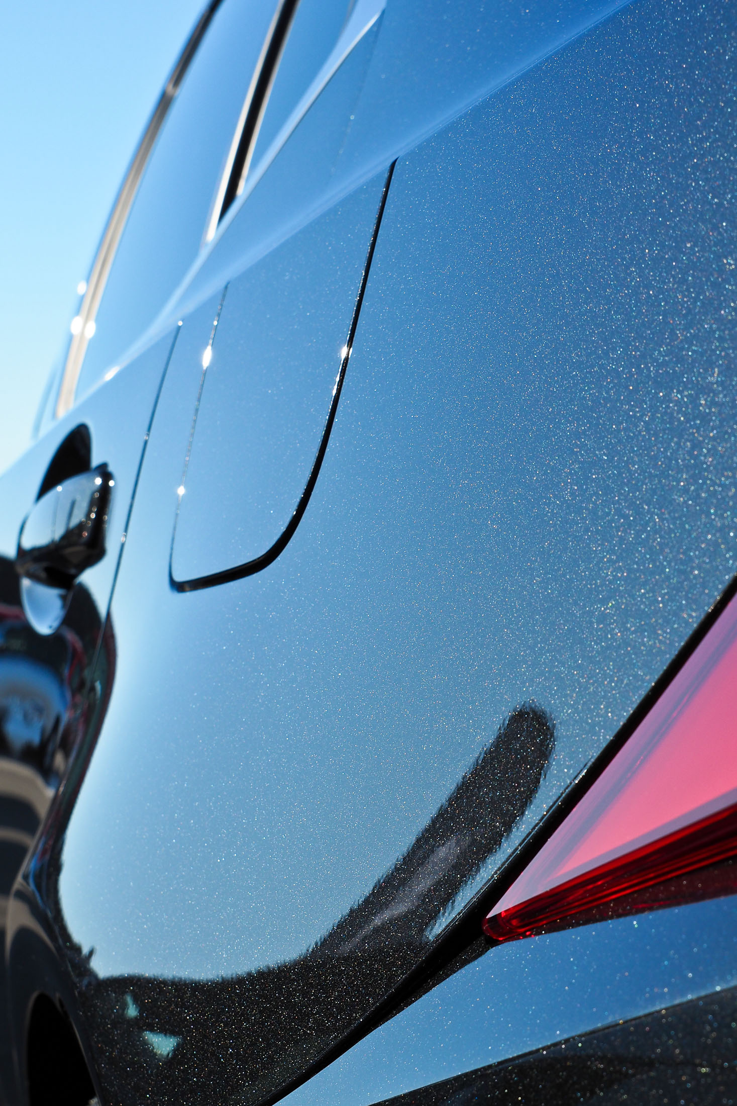 Close up of fleck reflecting in high gloss vehicle coating