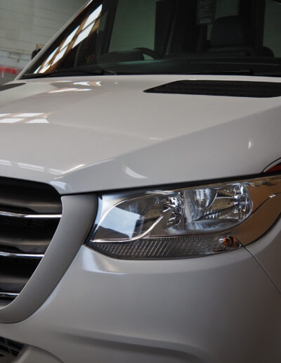 Left front and guard after coating applied - lights reflecting on bonnet