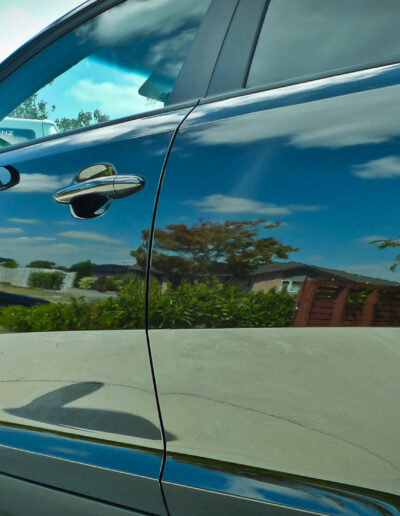 Left side of vehicle with reflections on paint