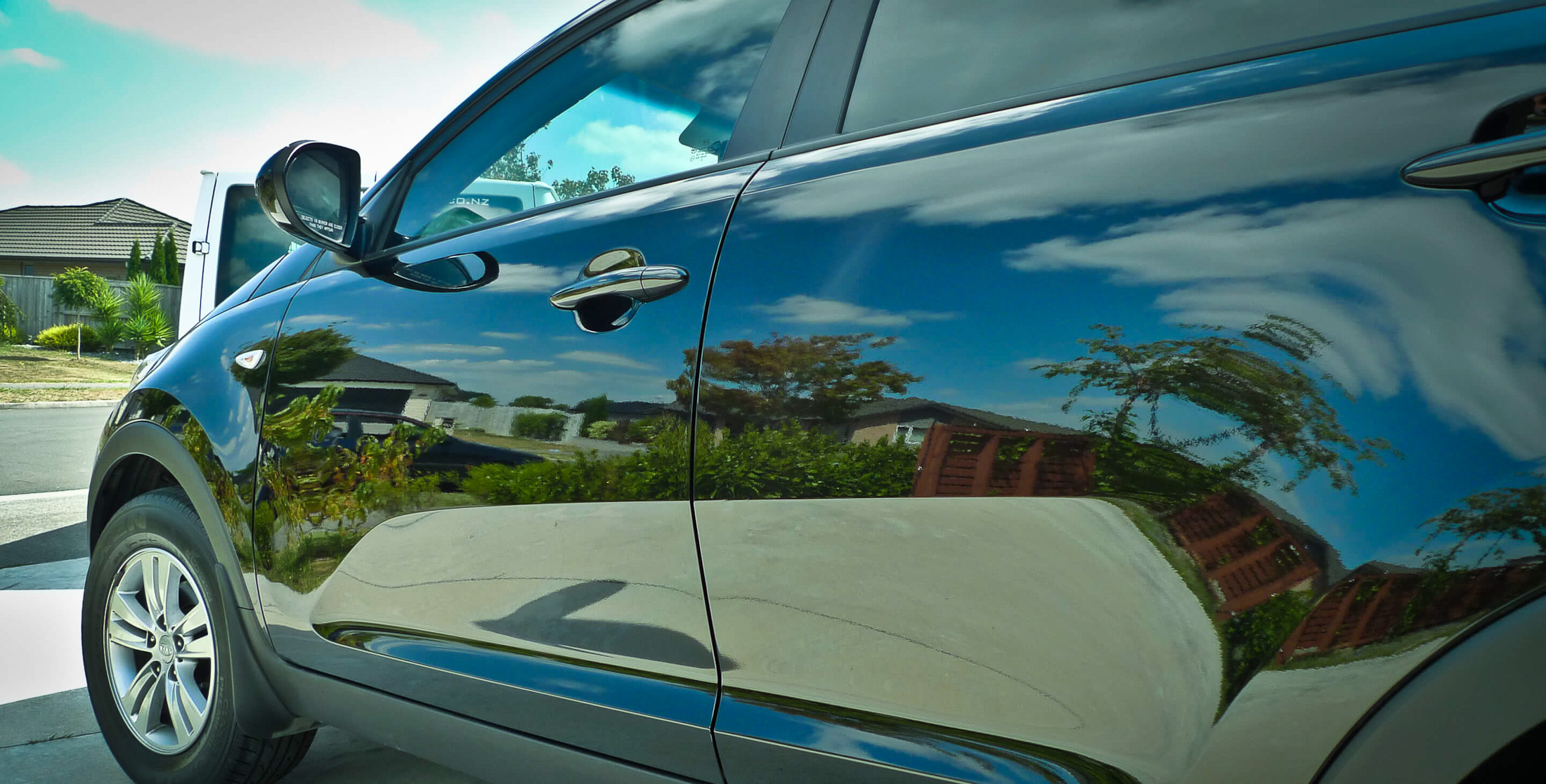 Left side of vehicle with reflections on paint