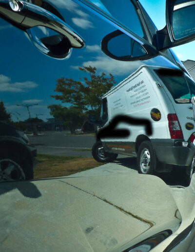 Drivers door with van reflecting on polished surface