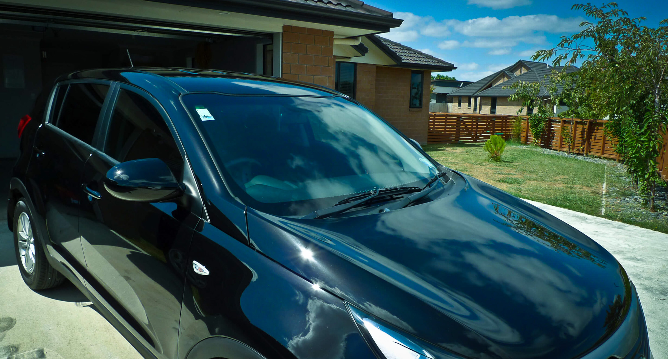 Clouds and sunlight reflecting on drivers side after full detailing paint chip repairs