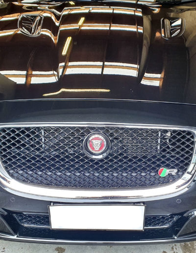 Front bonnet view with lights reflecting in paintwork after coating applied