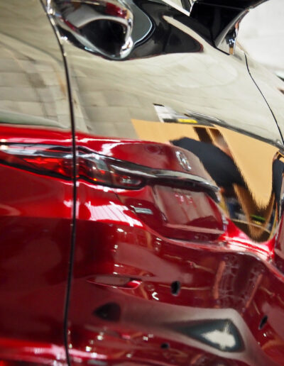 Red car reflecting in the drivers side after coating applied