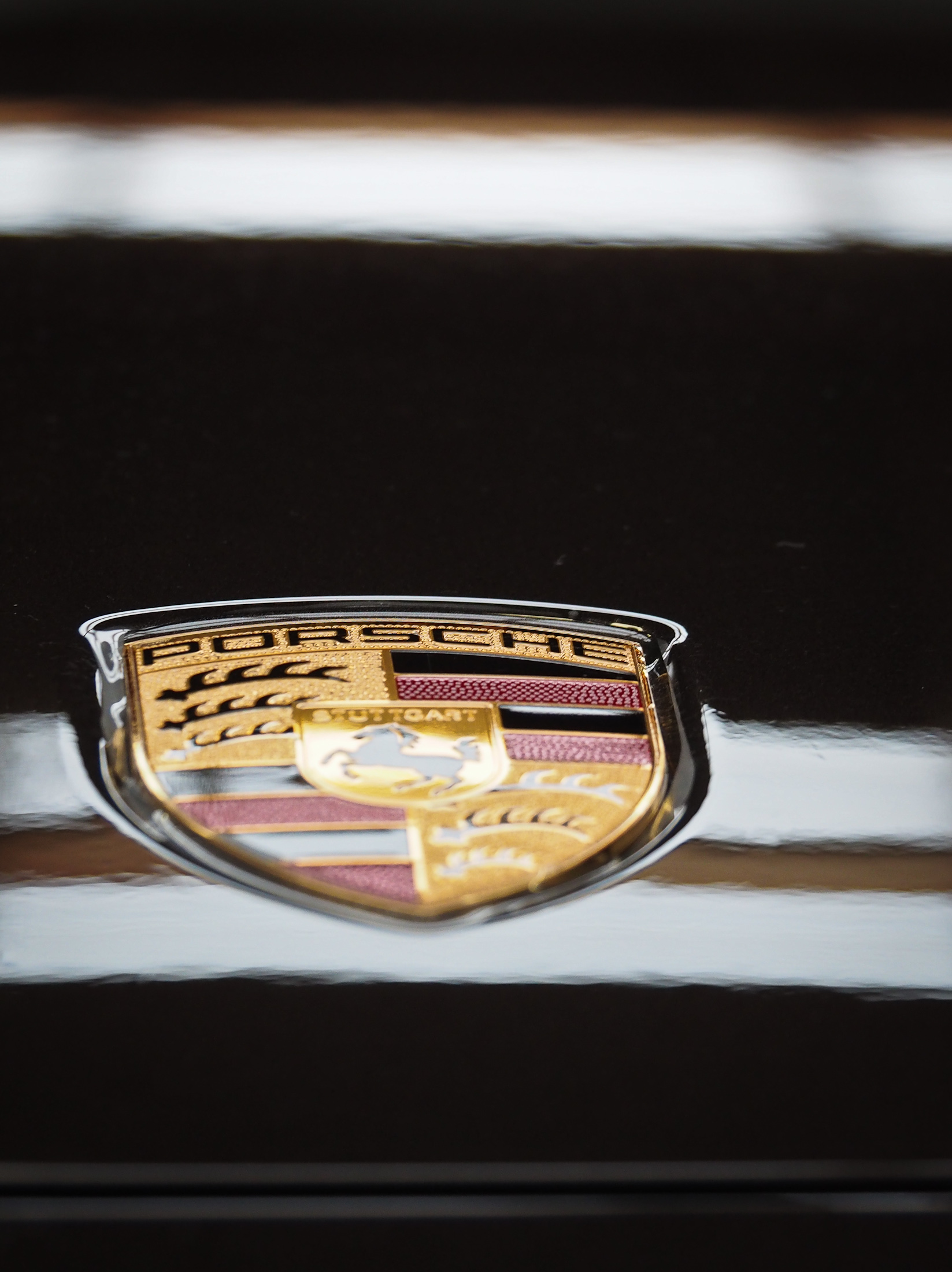 Close up of Porsche badge on bonnet