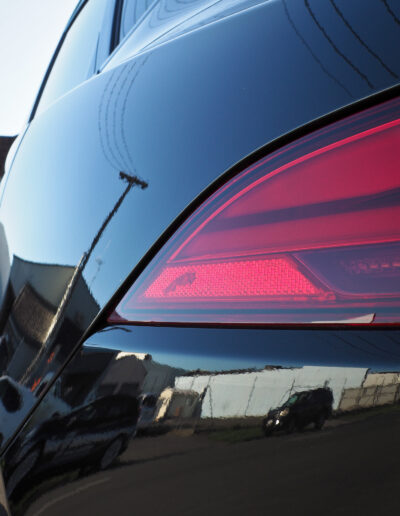 Power poles reflecting on left rear quarter panel