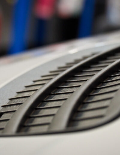 Close up of bonnet plastic air duct with coating applied