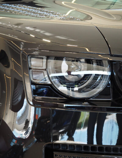 Right front headlight closeup after ceramic coating applied